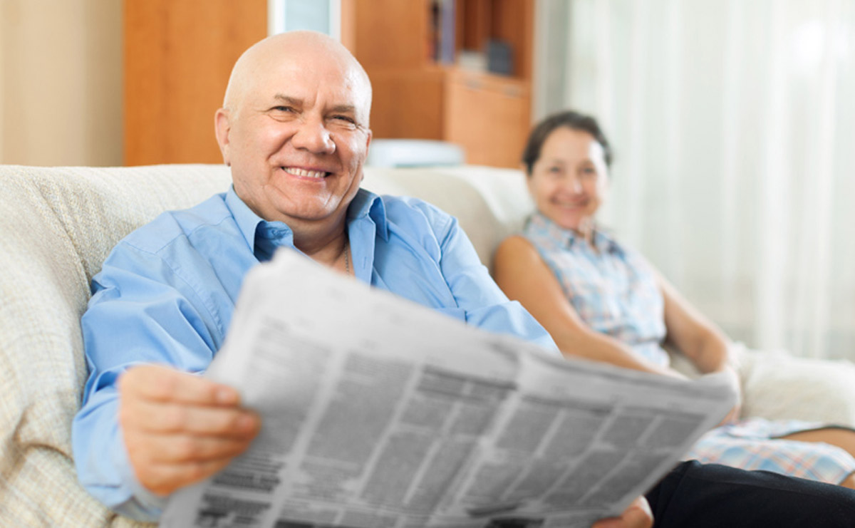 Older man reading a newspaper